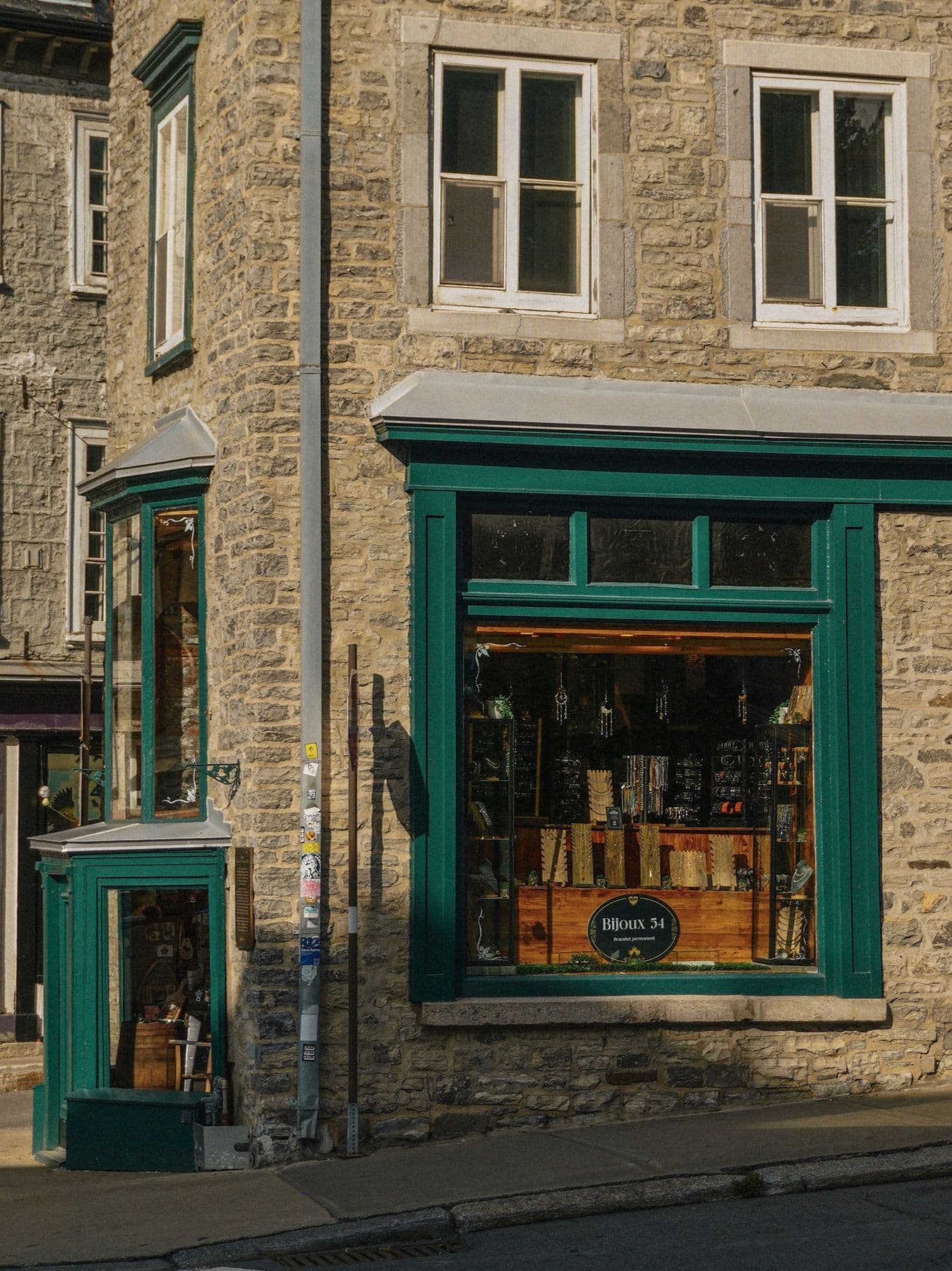 A traditional painted timber shopfront on a stone building