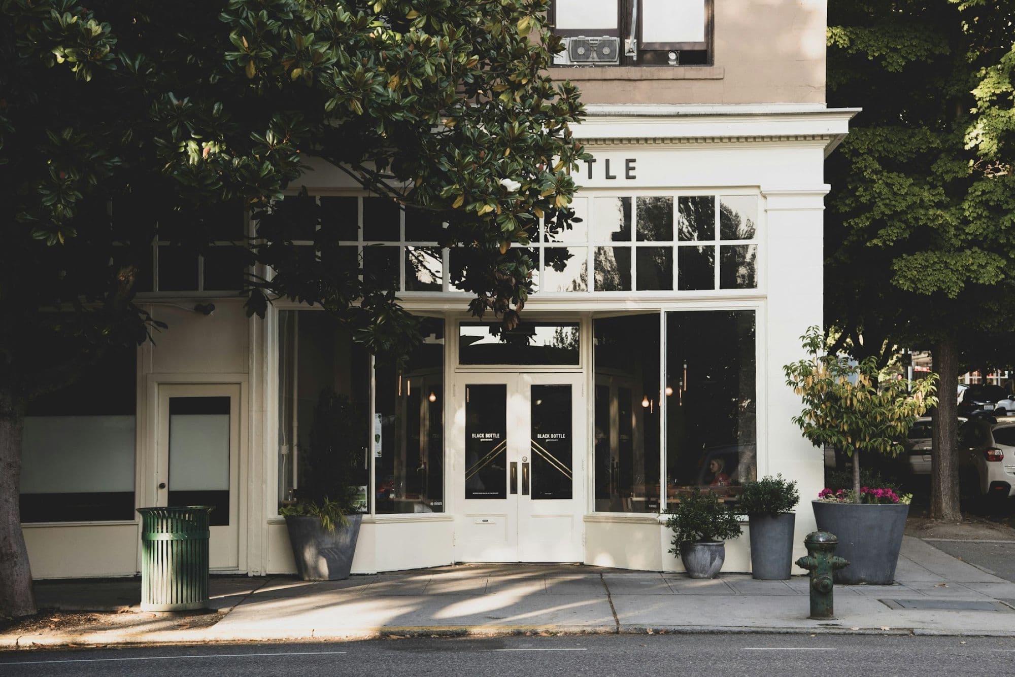 A white-painted shopfront with glazed double doors